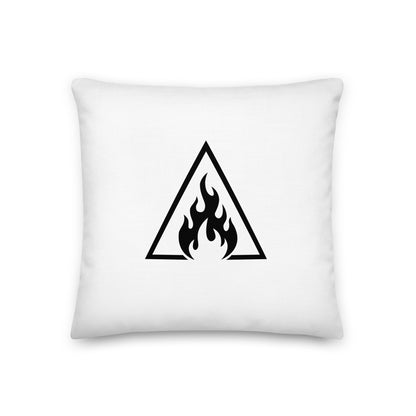 White pillow with a black triangle and flame design on a white background