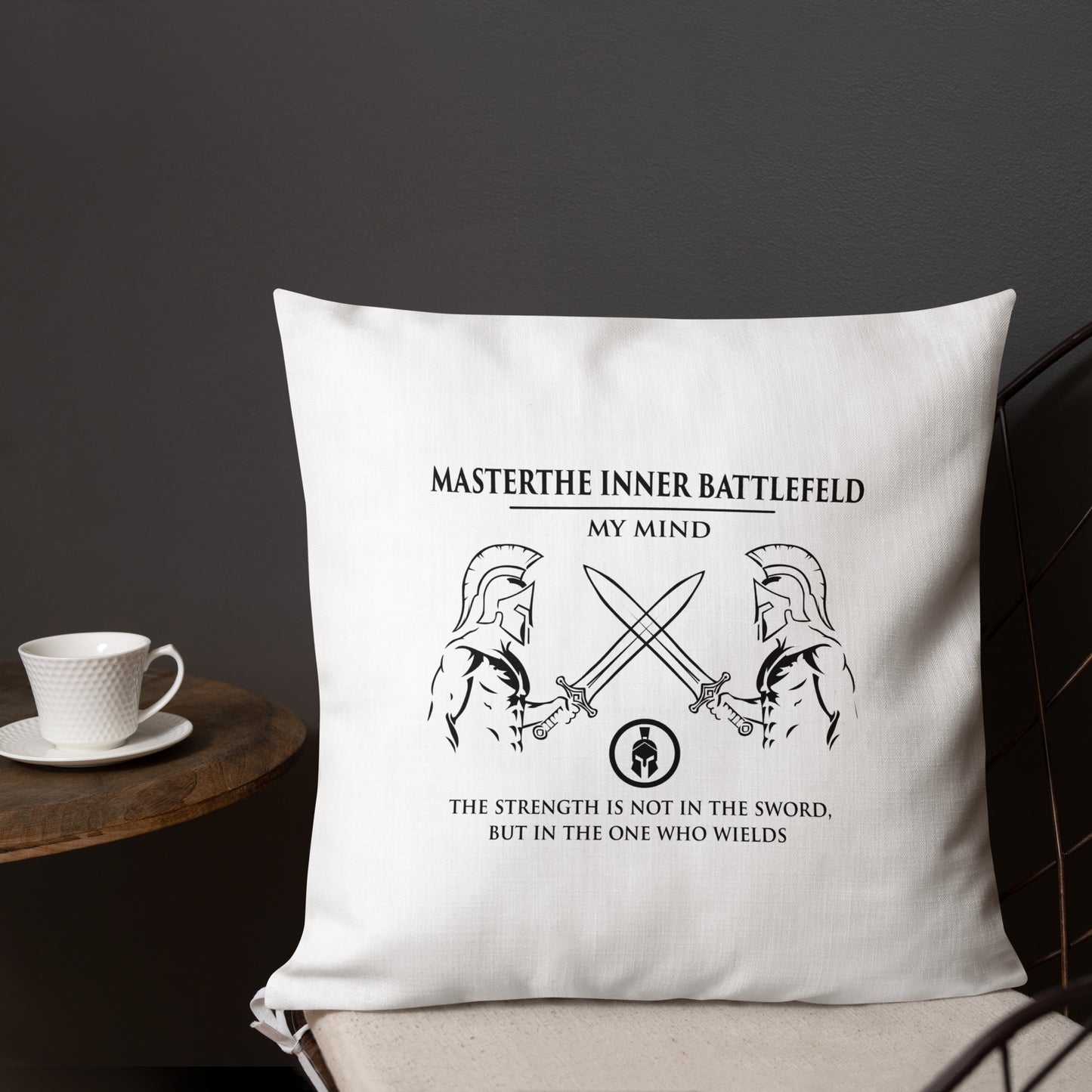 White pillow with motivational quote and warrior graphics on a dark background