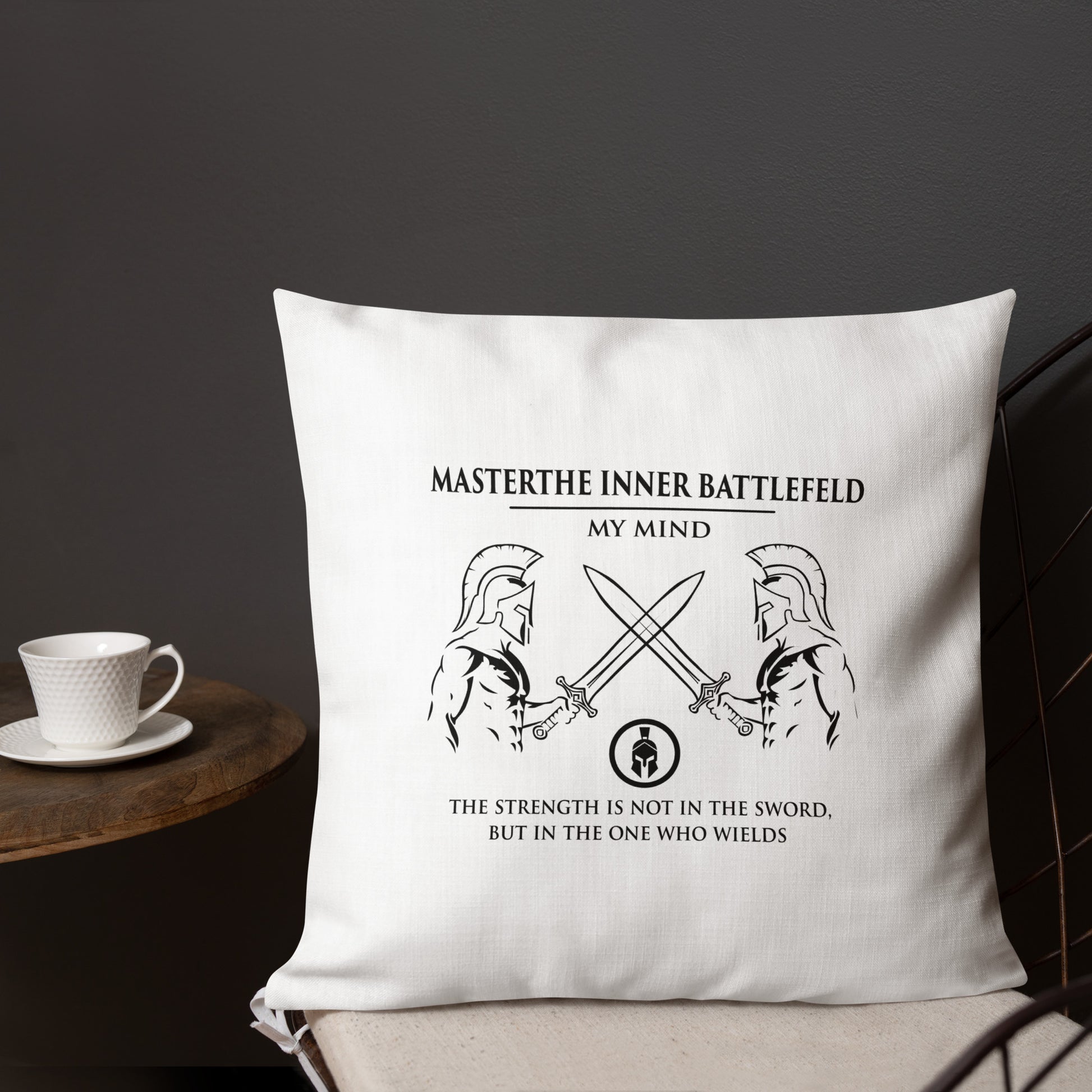 White pillow with motivational quote and warrior graphics on a dark background