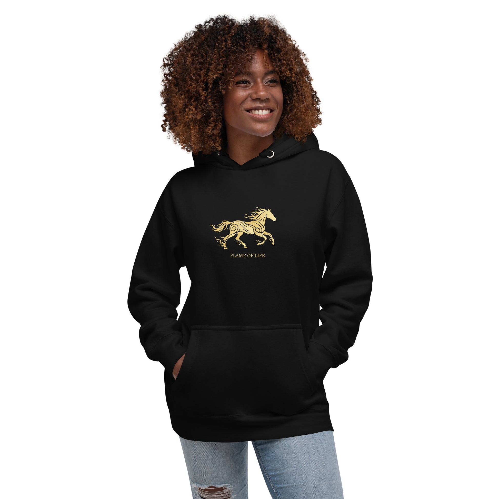Woman wearing a black hoodie with a a gold horse Flame of life design by the vision 2026.A symbol of inner fire, strength, and the spirit refuses to be tamed by the system.
