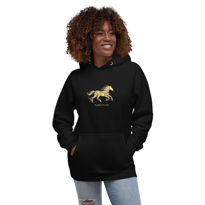 Woman wearing a black hoodie with a a gold horse Flame of life design by the vision 2026.A symbol of inner fire, strength, and the spirit refuses to be tamed by the system.