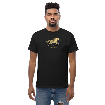 Man wearing a black t-shirt with  golden horse Flame of life design by the vision 2026.A symbol of inner fire, strength, and the spirit refuses to be tamed by the system.