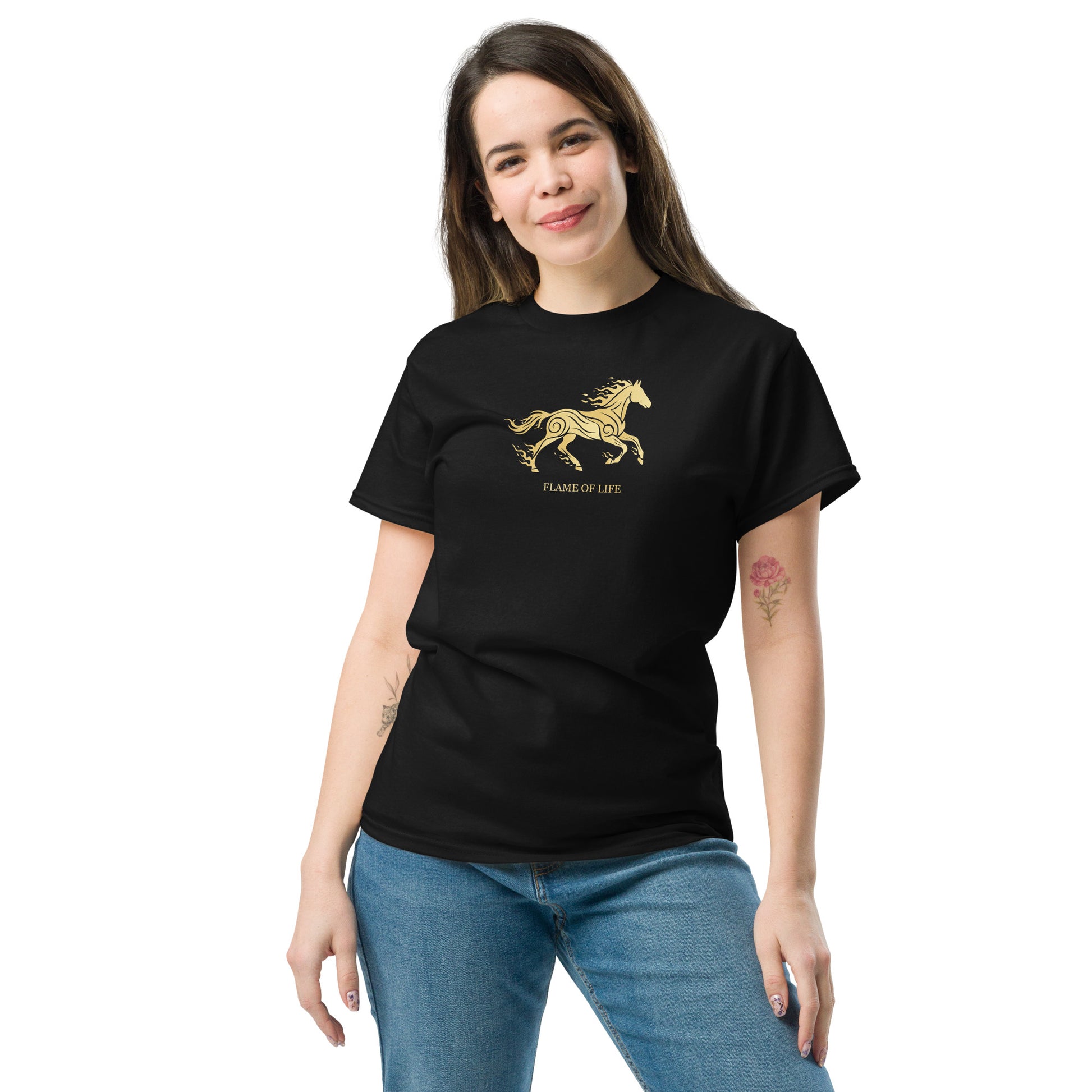 Woman wearing a black t-shirt with  golden horse Flame of life design by the vision 2026.A symbol of inner fire, strength, and the spirit refuses to be tamed by the system.