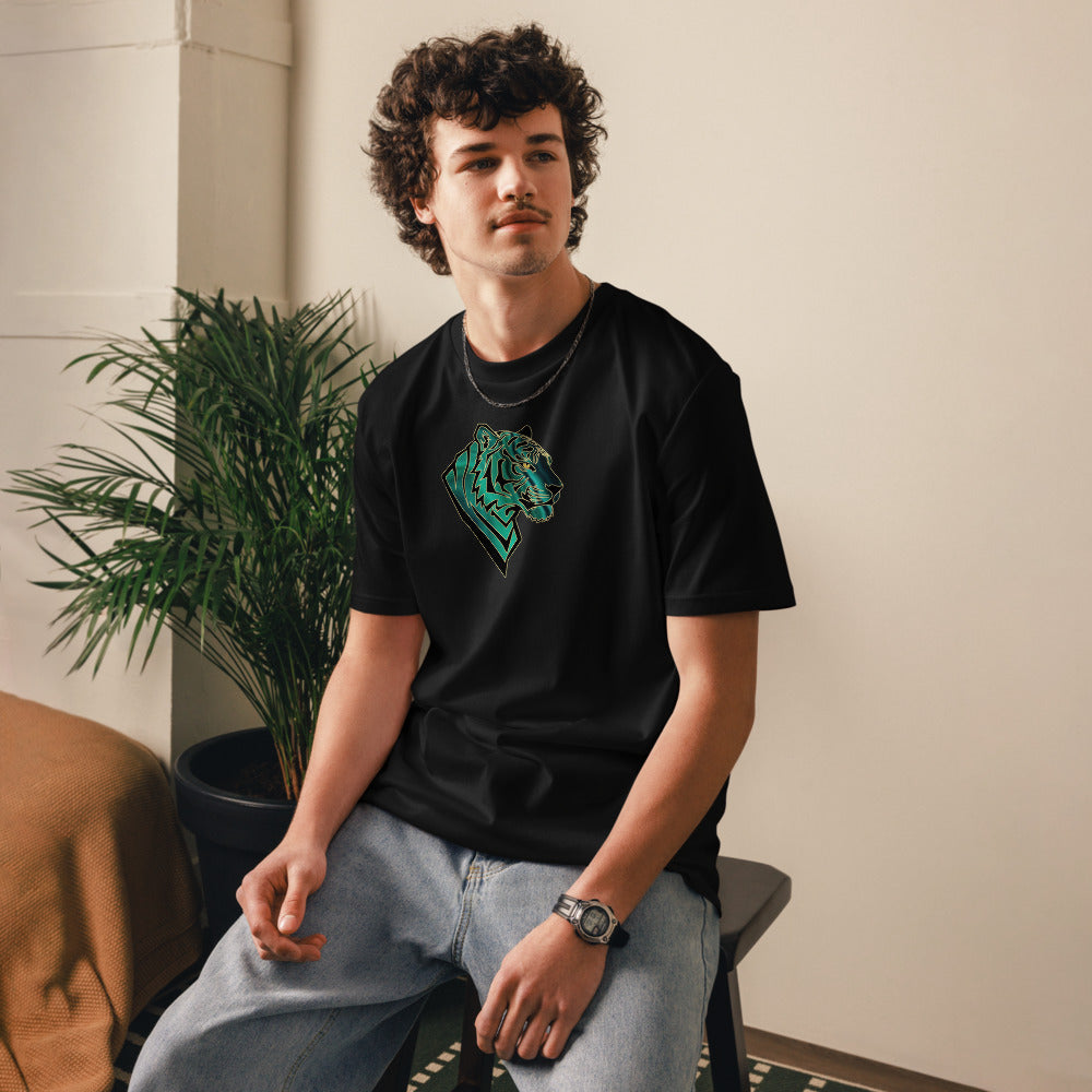 Person wearing a black t-shirt with a green graphic design, sitting indoors.